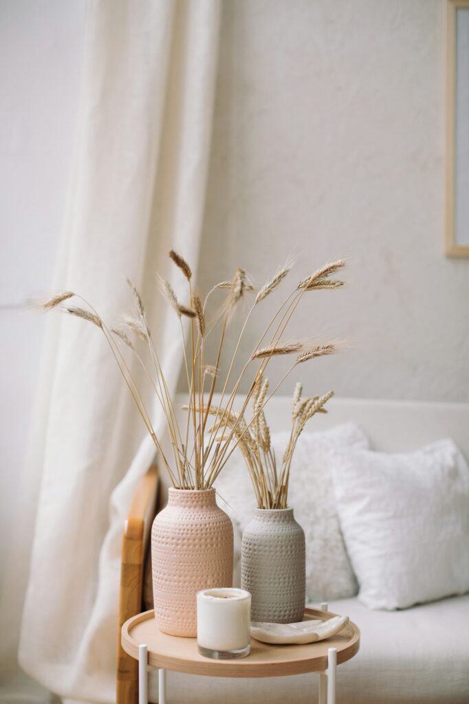 Still life shot of rye or wheat ear stalk in vases. Living room interior.